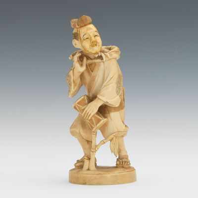 Appraisal: A Japanese Carved Ivory Man with a Drum Tea-stained carved