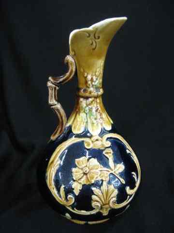 Appraisal: Majolica Pottery Vase floral on deep blue field ewer shape