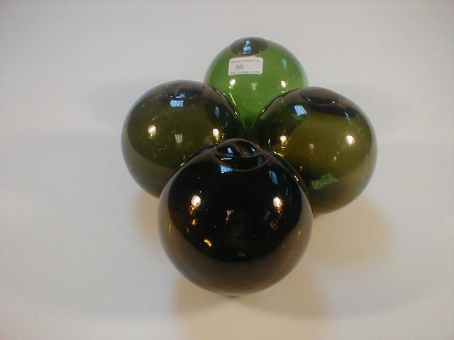 Appraisal: Four green glass floats high