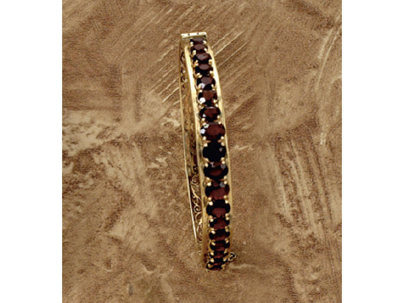 Appraisal: GARNET BANGLE BRACELET k yellow gold with oval garnets graduated