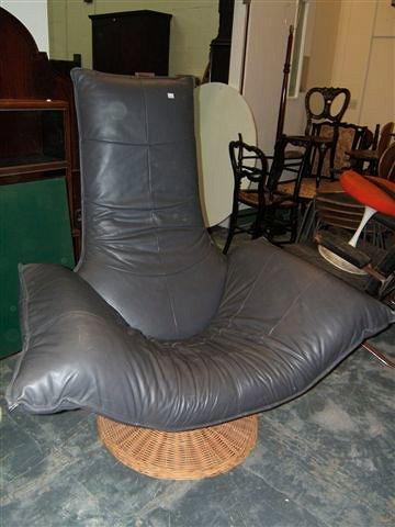 Appraisal: A late th Century grey leather upholstered designer chair on