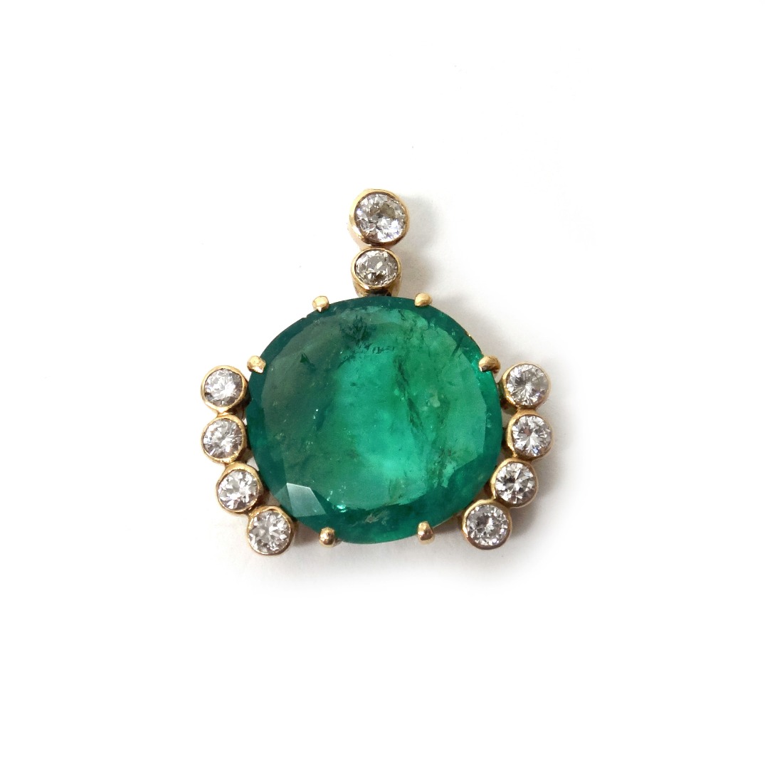 Appraisal: A gold emerald and diamond pendant mounted with the cushion