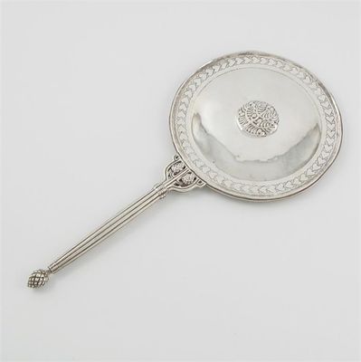 Appraisal: A hand made hand mirror with an openwork reeded handle