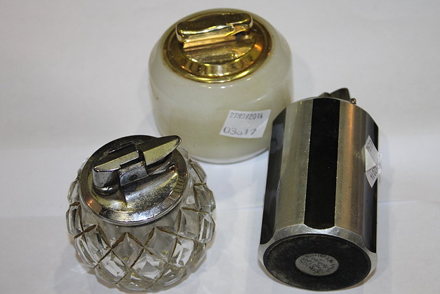 Appraisal: THREE VARIOUS STYLISED CIGARETTE LIGHTERS including an example by Ronson