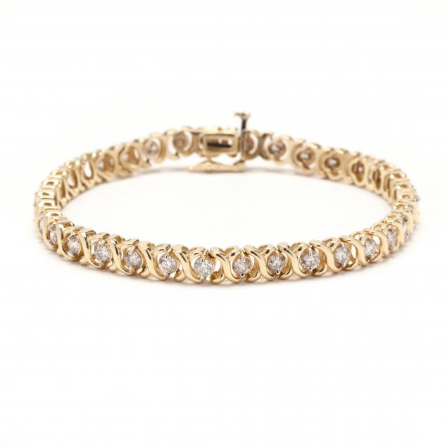 Appraisal: GOLD AND DIAMOND BRACELET Designed in an XO motif set