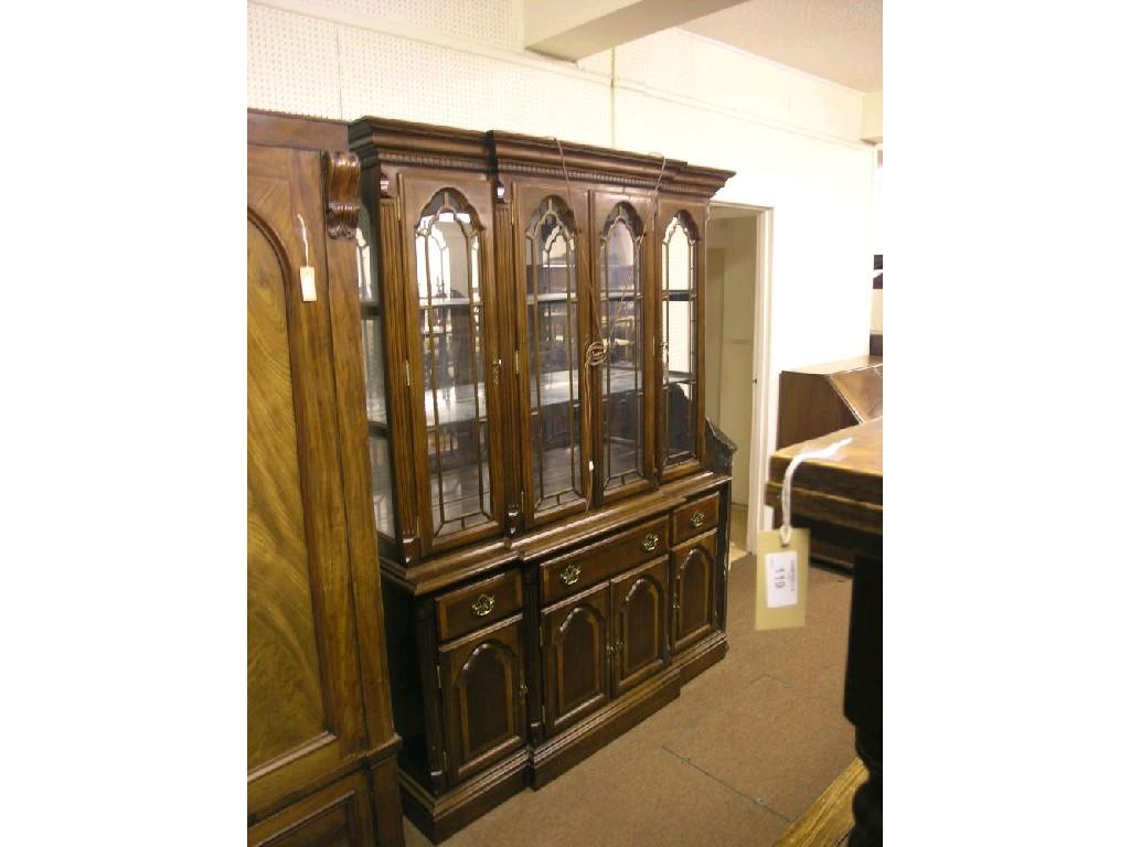 Appraisal: A large mahogany break-front display cabinet upper stage enclosed by