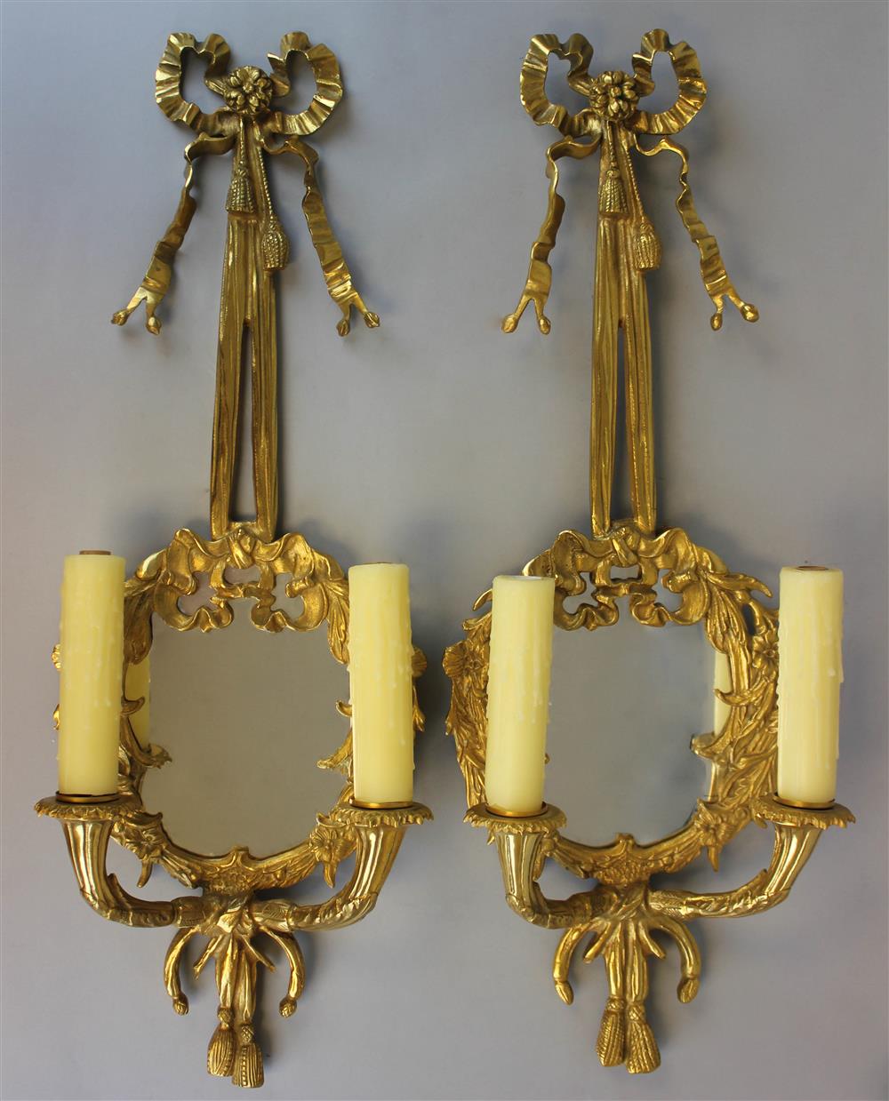 Appraisal: PAIR OF CONTINENTAL ROCOCO STYLE GILT BRONZE MIRRORED TWO-LIGHT SCONCES