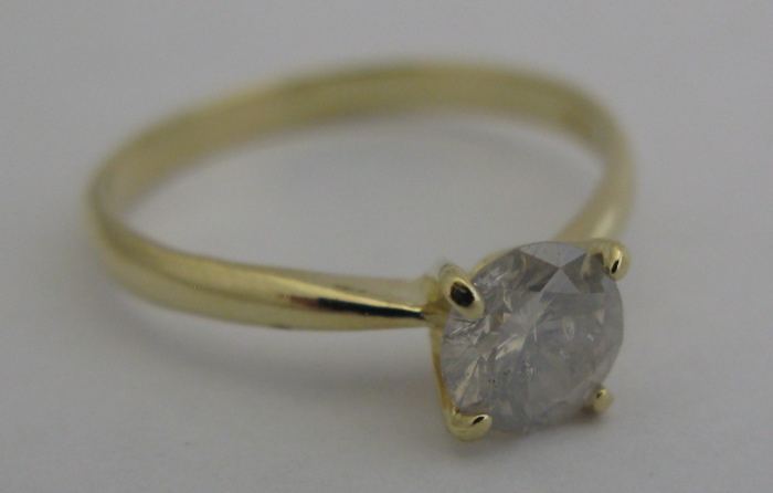 Appraisal: DIAMOND AND K GOLD SOLITAIRE RING centered and prong set