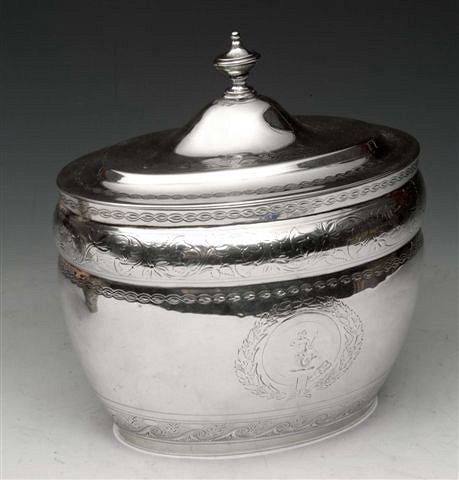 Appraisal: A GEORGE III SILVER OVAL TEA CADDY with engraved foliate