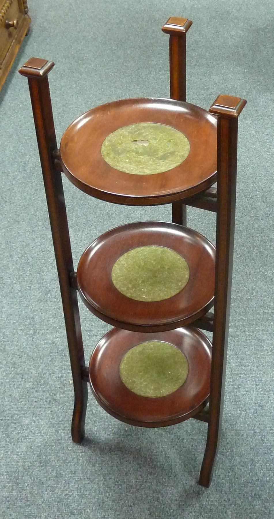 Appraisal: A three-tier cake stand on three inlaid square supports cm