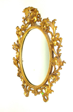 Appraisal: A Florentine carved and giltwood oval mirror frame deeply carved