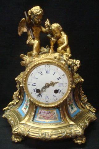 Appraisal: Bronze Clock with Porcelain Panels and Putti Missing back cover