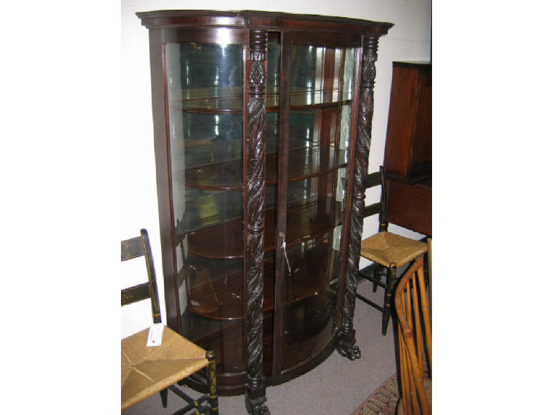 Appraisal: AMERICAN CURIO CABINET The shaped top above a glazed convexed