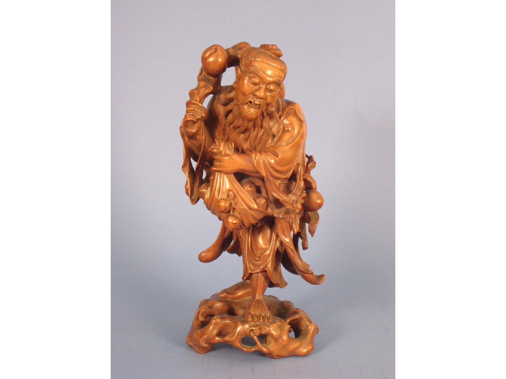 Appraisal: A Japanese carved wood Figure carrying fruit in