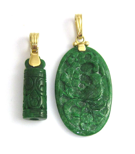 Appraisal: TWO CHINESE CARVED JADE PENDANTS each with a k yellow