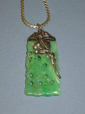 Appraisal: AN ART DECO JADE PENDANT of tapering oblong form carved