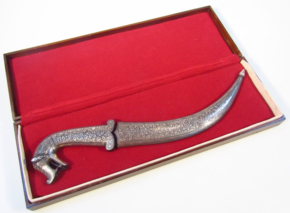 Appraisal: A decorative curved dagger probably Indian with a white metal