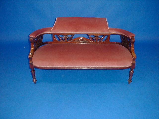 Appraisal: A Victorian walnut boudoir two seater sofa upholstered in pink