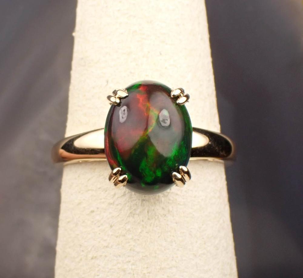 Appraisal: ETHIOPIAN BLACK OPAL AND FOURTEEN KARAT GOLD RING The yellow