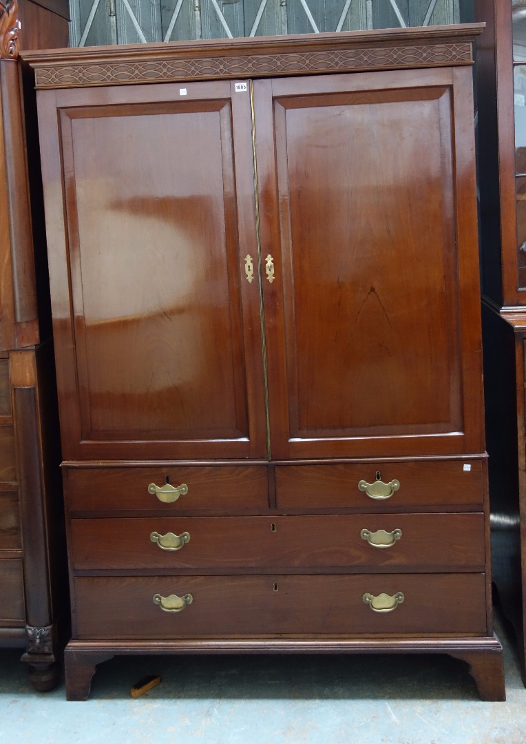 Appraisal: A George III mahogany linen press the pair of panel