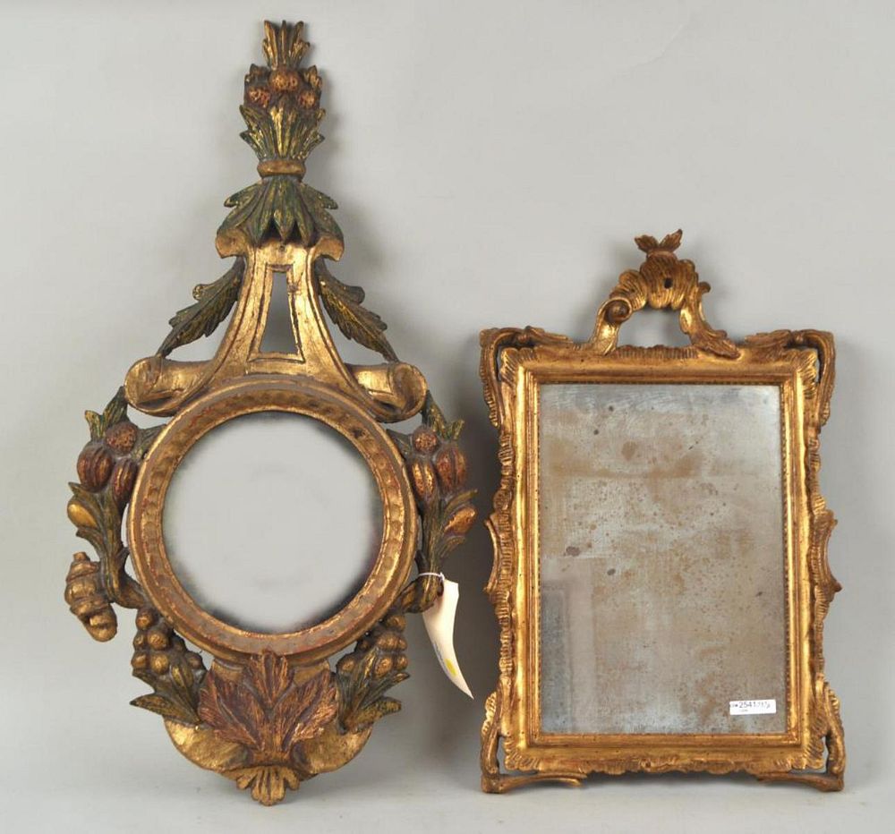 Appraisal: Two Continental Carved Wood Gilt Mirrors largest with fruit foliate