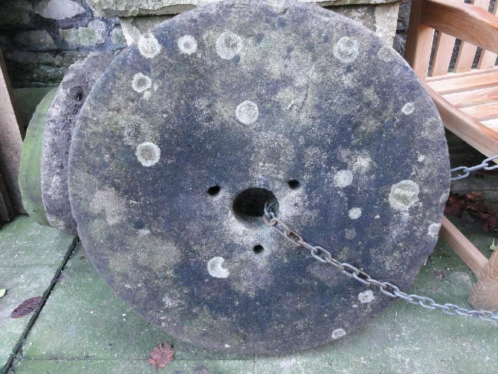 Appraisal: A weathered natural stone mill stone diameter approximately