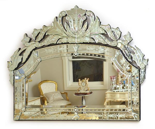 Appraisal: A VENETIAN STYLE WALL MIRROR WITH A SEGMENTED ETCHED SURROUND