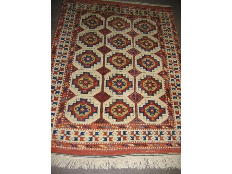 Appraisal: TURKISH THROW RUG The ivory field shows an allover repetitive