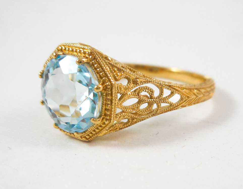 Appraisal: AQUAMARINE AND FOURTEEN KARAT GOLD RING The yellow gold filigree