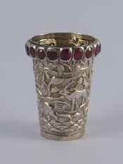 Appraisal: A white metal tests silver Eastern tot cup embossed with