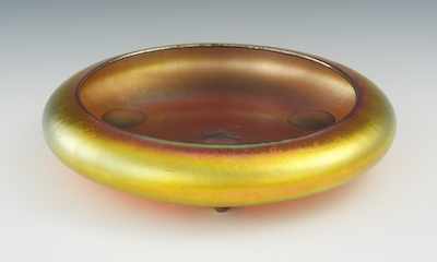 Appraisal: A Steuben Aurene Footed Bowl The low squat glass bowl