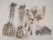 Appraisal: Two pairs of cast silver plated continental salad servers together