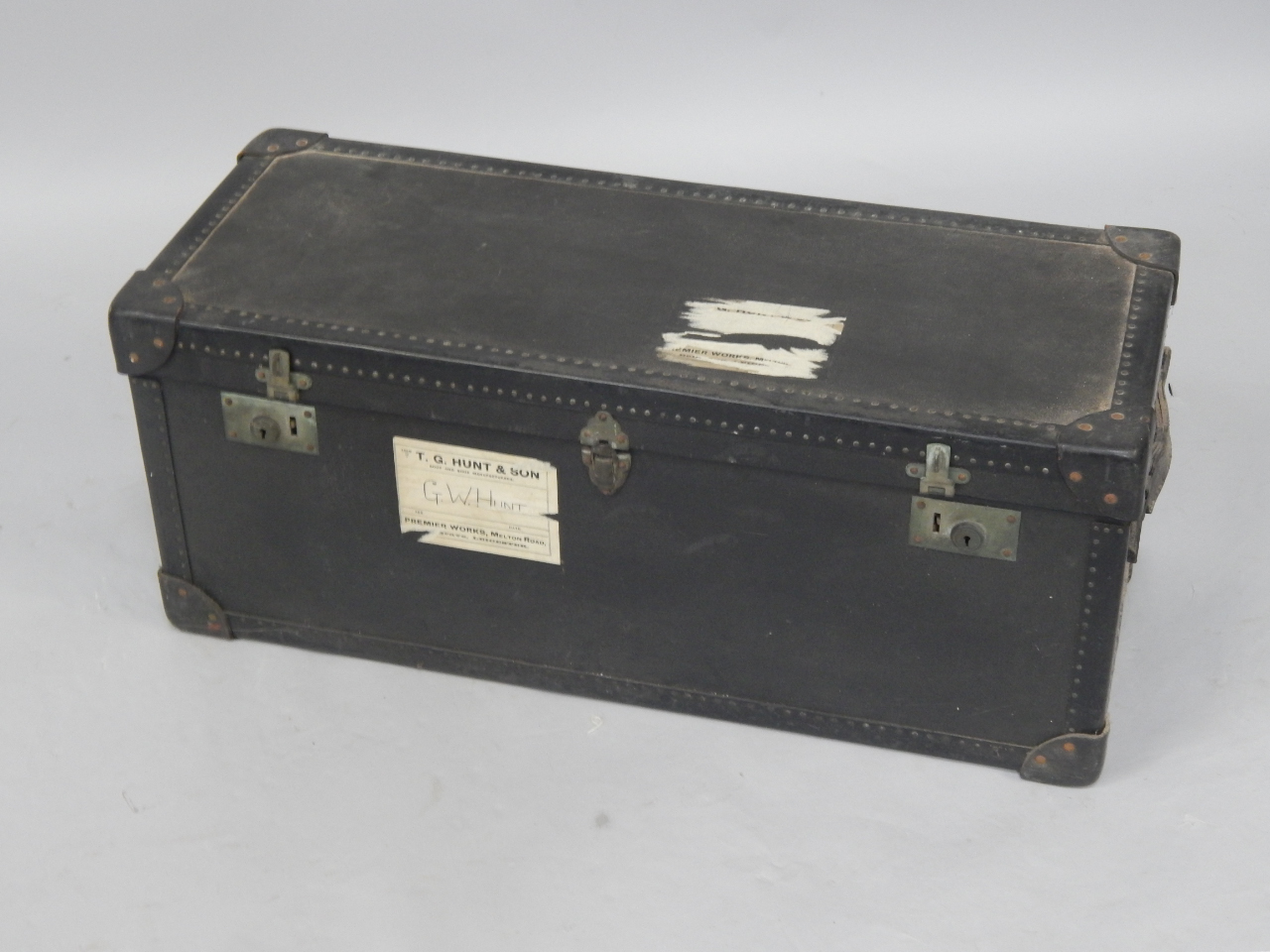 Appraisal: An A Potterton black travelling trunk with leather carrying handles