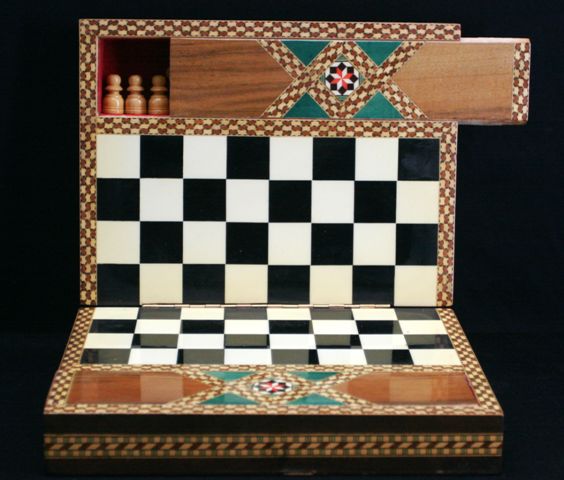 Appraisal: A chess set in hinged inlaid box with chess pieces