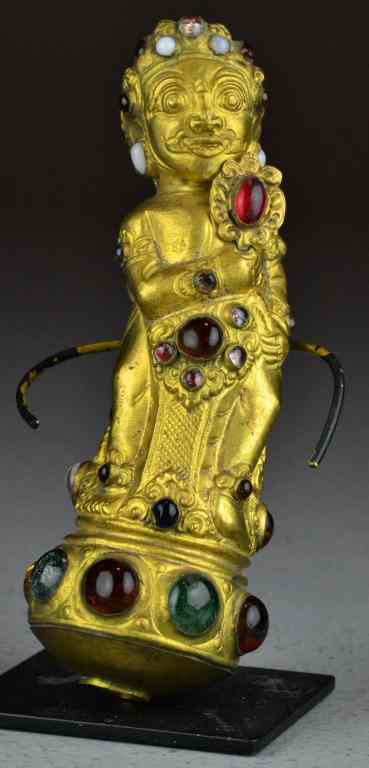 Appraisal: Tibetan Gilt Copper and jeweled Parasol HandleDepicting a standing figure