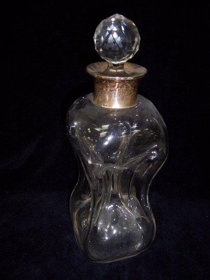 Appraisal: A silver mounted decanter of hourglass form the collar Birmingham