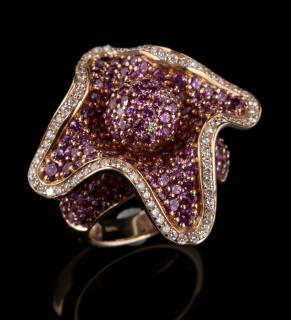 Appraisal: AN AMETHYST AND DIAMOND FLOWER-FORM FASHION RING An amethyst encrusted