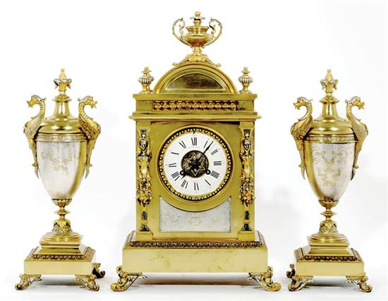 Appraisal: Edwardian parcel-gilt metal clock garniture Elkington Co circa architectural case