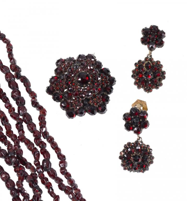 Appraisal: AN ANTIQUE GARNET TORSADE NECKLACE AND AN ANTIQUE GARNET CLUSTER