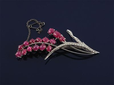 Appraisal: A white gold floral brooch set with cabachon rubies and