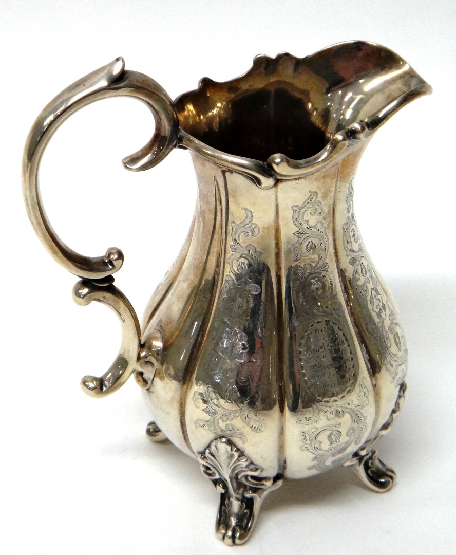 Appraisal: A Victorian silver milk jug of baluster form with fluted