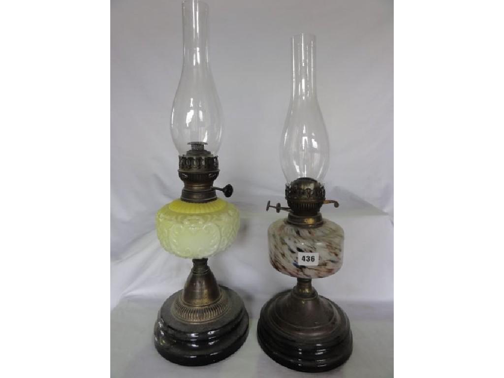 Appraisal: Two late th century oil lamps both with glass reservoirs