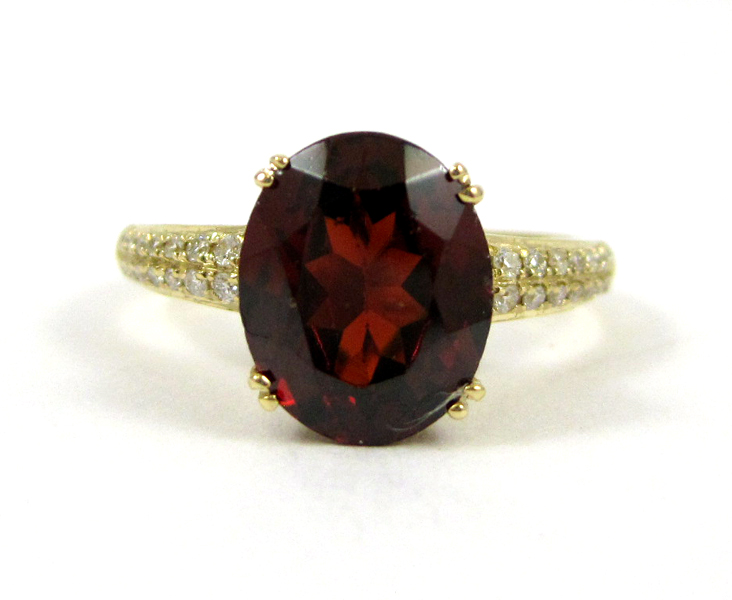 Appraisal: GARNET DIAMOND AND FOURTEEN KARAT GOLD RING with round-cut diamonds