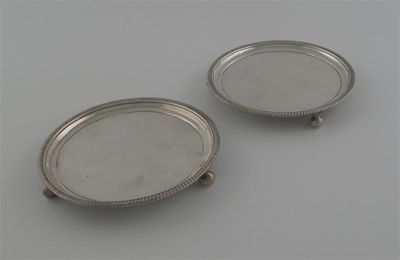 Appraisal: A pair of George III waiters with gadrooned border and