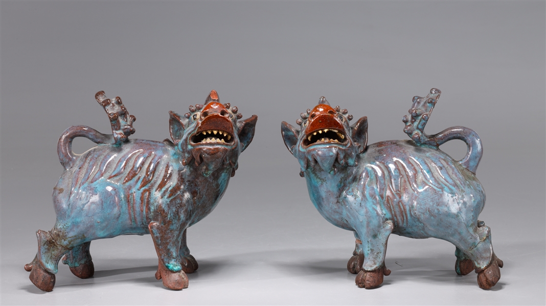 Appraisal: Pair Chinese glazed ceramic mythical creatures as-is condition with chips