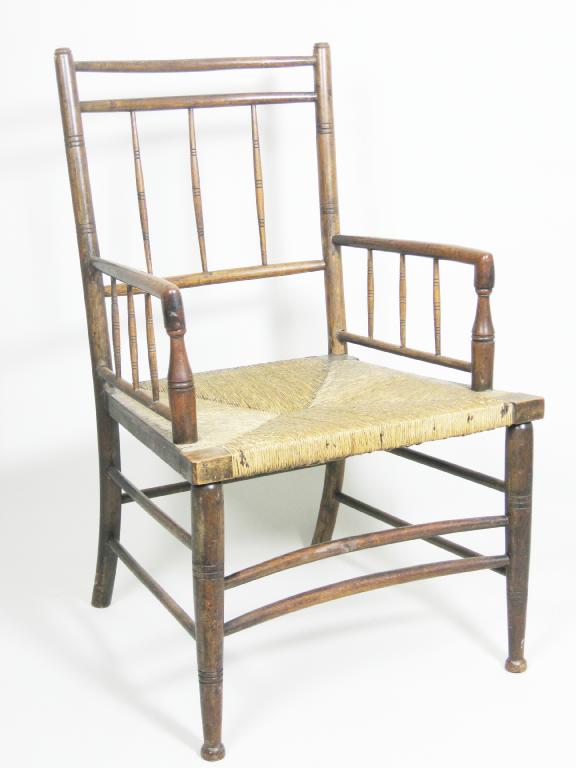 Appraisal: An Arts Crafts Elbow Chair with spindle back rush seat