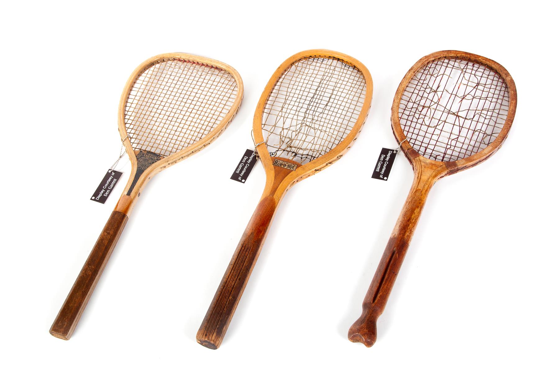 Appraisal: THREE TENNIS RACKETS Twentieth century Wooden frames with natural stringing