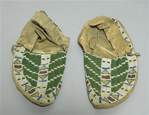 Appraisal: PAIR SIOUX BEADED HIDE MOCASSINS The geometric design with green