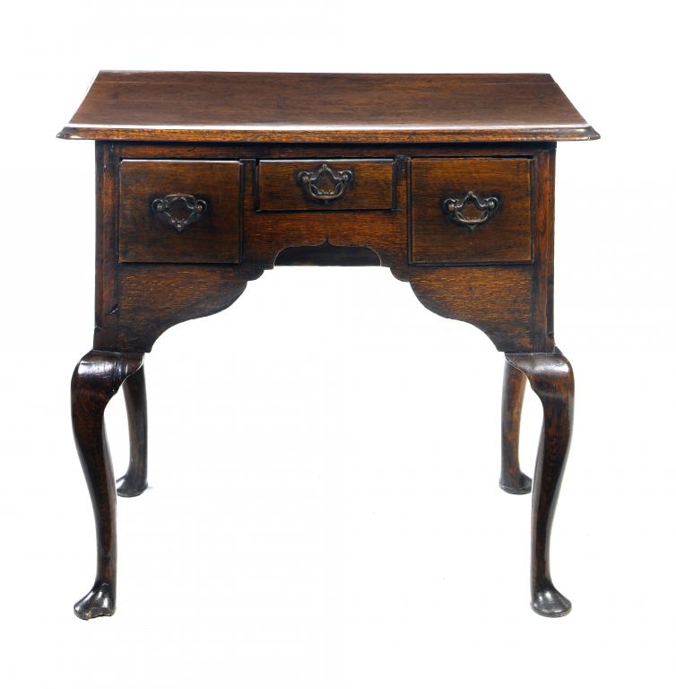 Appraisal: A GEORGE III OAK LOWBOY with three moulded drawers to