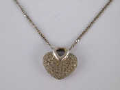 Appraisal: A white metal tests carat gold pave set diamond heart